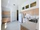 Kitchen features white appliances, clerestory windows, and light wood cabinets at 860 Wolf Creek St, Clermont, FL 34711