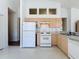 Functional kitchen with white appliances and wood cabinets at 860 Wolf Creek St, Clermont, FL 34711