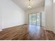 Bright living room with vaulted ceilings, laminate flooring, and a sliding door to the lanai at 860 Wolf Creek St, Clermont, FL 34711