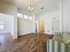Open living room featuring hardwood floors, a modern light fixture, and natural light from the windows at 860 Wolf Creek St, Clermont, FL 34711