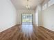 Spacious living room featuring wood floors and sliding glass doors to the outside patio at 860 Wolf Creek St, Clermont, FL 34711