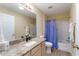 Bright bathroom with granite counters, shower, and tub combo at 870 Danforth Ct, The Villages, FL 32162