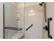 Glass enclosed shower with handrails and corner seat, offering a luxurious bathing experience at 870 Danforth Ct, The Villages, FL 32162