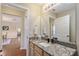 Bathroom with granite counters and view into hallway at 870 Danforth Ct, The Villages, FL 32162
