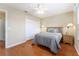 Cozy bedroom with closet, ceiling fan, wood floor, and ensuite at 870 Danforth Ct, The Villages, FL 32162