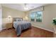 Comfortable bedroom features wood floors, natural light, and neutral colors at 870 Danforth Ct, The Villages, FL 32162