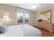 Well-lit bedroom with wood floors, ceiling fan, and dresser at 870 Danforth Ct, The Villages, FL 32162