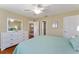 Primary bedroom view featuring a large bed, dresser, and access to the dining room at 870 Danforth Ct, The Villages, FL 32162
