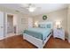 Serene bedroom featuring a queen bed, two nightstands, and an ensuite bathroom at 870 Danforth Ct, The Villages, FL 32162