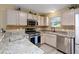 Modern kitchen featuring stainless steel appliances and granite countertops at 870 Danforth Ct, The Villages, FL 32162