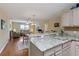 Open kitchen with a breakfast bar overlooking the living and dining areas at 870 Danforth Ct, The Villages, FL 32162