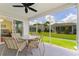 Screened lanai with seating area and outdoor view at 870 Danforth Ct, The Villages, FL 32162