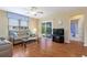 Bright living room featuring sliding glass doors to the lanai, comfortable seating, and a ceiling fan at 870 Danforth Ct, The Villages, FL 32162
