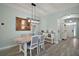 Elegant dining room featuring a stylish light fixture and seamless entry to the foyer at 879 Lucky Ln, The Villages, FL 32162