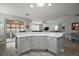 Bright kitchen featuring a breakfast bar and open floor plan concept to the dining and living areas at 879 Lucky Ln, The Villages, FL 32162