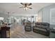 Open living space featuring hardwood floors, an island bar and seamless connectivity to the kitchen at 879 Lucky Ln, The Villages, FL 32162