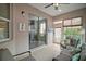 Relaxing sunroom with tile flooring, a ceiling fan, comfortable seating, and screened windows at 879 Lucky Ln, The Villages, FL 32162