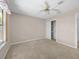 Carpeted bedroom with a closet and ceiling fan offers comfortable living space at 1061 Soledad Way, The Villages, FL 32159