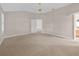 Primary bedroom with carpet, ceiling fan, and an open doorway, creating an inviting and airy atmosphere at 1061 Soledad Way, The Villages, FL 32159