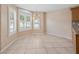 Cozy breakfast nook featuring plantation shutters, tile floors, a chandelier, and a picturesque view at 1061 Soledad Way, The Villages, FL 32159
