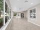 Spacious sunroom with tile flooring, large windows, and a ceiling fan providing natural light and comfort at 1061 Soledad Way, The Villages, FL 32159