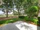 Lush backyard featuring mature trees and landscaping, perfect for enjoying the outdoors at 1061 Soledad Way, The Villages, FL 32159