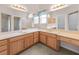 Bright bathroom featuring double sinks, generous counter space, and well-lit mirrors, offering functionality and style at 1061 Soledad Way, The Villages, FL 32159