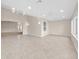 Versatile bonus room with tiled floors, bright windows, and contemporary lighting, ideal for various activities at 1061 Soledad Way, The Villages, FL 32159