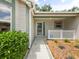 Charming front entrance with a white picket fence and lush greenery, providing a welcoming appeal at 1061 Soledad Way, The Villages, FL 32159