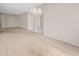 Spacious living room with plush carpeting, a chandelier, and ample natural light, ideal for relaxation at 1061 Soledad Way, The Villages, FL 32159