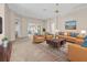 Bright living room with comfortable seating, stylish decor, and open access to adjacent rooms, creating a welcoming space at 1061 Soledad Way, The Villages, FL 32159