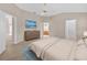 Serene main bedroom with vaulted ceiling, a dresser with TV, and access to the en-suite bathroom and walk-in closet at 1061 Soledad Way, The Villages, FL 32159