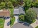 Aerial view of a home featuring mature trees and a screened outdoor space at 1105 Del Toro Dr, The Villages, FL 32159