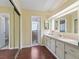 Bright bathroom with double mirrors, good cabinet space, and a linen closet at 1105 Del Toro Dr, The Villages, FL 32159