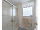 Bright bathroom with a glass shower, window, and towel rack with towels at 1105 Del Toro Dr, The Villages, FL 32159