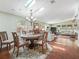Bright dining area with hardwood floors, chandelier, and skylights filtering natural light at 1105 Del Toro Dr, The Villages, FL 32159