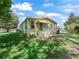 Charming home exterior with well-maintained landscaping and a cozy seating area at 1105 Del Toro Dr, The Villages, FL 32159