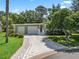 Charming single-story home with a well-manicured lawn, two-car garage, and inviting entryway at 1105 Del Toro Dr, The Villages, FL 32159