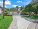 Charming single-story home featuring a decorative driveway, manicured lawn, and covered entryway at 1105 Del Toro Dr, The Villages, FL 32159