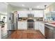 Bright kitchen featuring stainless steel appliances, light cabinets, and hardwood floors at 1105 Del Toro Dr, The Villages, FL 32159
