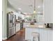 Bright kitchen with stainless steel appliances, white cabinets, and a breakfast bar seating area at 1105 Del Toro Dr, The Villages, FL 32159