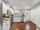 Well-lit kitchen features stainless steel appliances, light cabinets, and hardwood floors at 1105 Del Toro Dr, The Villages, FL 32159