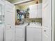 Efficient laundry closet with washer, dryer, and shelving at 1105 Del Toro Dr, The Villages, FL 32159
