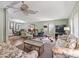 Spacious living room featuring hardwood floors, a ceiling fan, and large windows at 1105 Del Toro Dr, The Villages, FL 32159