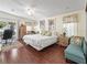 Spacious main bedroom with hardwood floors and sliding door access to the lanai at 1105 Del Toro Dr, The Villages, FL 32159