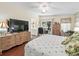 Light-filled main bedroom with hardwood floors and an adjacent bathroom at 1105 Del Toro Dr, The Villages, FL 32159