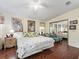 Main bedroom with hardwood floors, a mirrored closet, and tropical decor at 1105 Del Toro Dr, The Villages, FL 32159