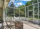 Enjoy outdoor living in this bright, screened-in patio with comfortable lounge chairs and scenic views at 1105 Del Toro Dr, The Villages, FL 32159