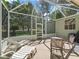 Inviting screened-in patio with lounge chairs and ample seating, overlooking a serene outdoor space at 1105 Del Toro Dr, The Villages, FL 32159