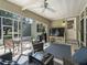 Relaxing screened-in patio with comfortable seating, ceiling fan, and outdoor television at 1105 Del Toro Dr, The Villages, FL 32159